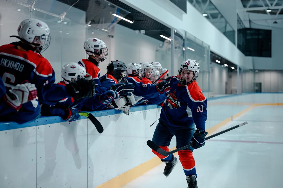 Giocatrice di hockey su ghiaccio esulta dopo un gol durante una partita internazionale