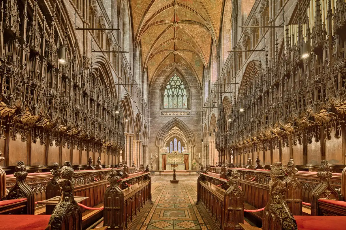 Empty cathedral nave with a single lit candle on the altar, distant blurred pews, quiet atmosphere