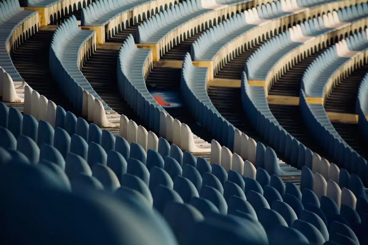 Empty stadium stands with a single anniversary banner and empty seats, no identifiable people