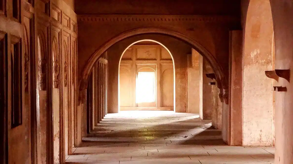 empty municipal corridor with a single flagged chair and a closed door, sunlight across the floor, institutional atmosphere suggesting order and vigilance