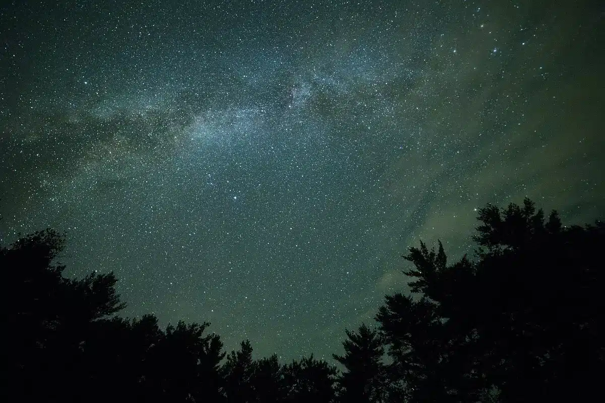 Sagoma anonima di un androide che fugge in una città illuminata