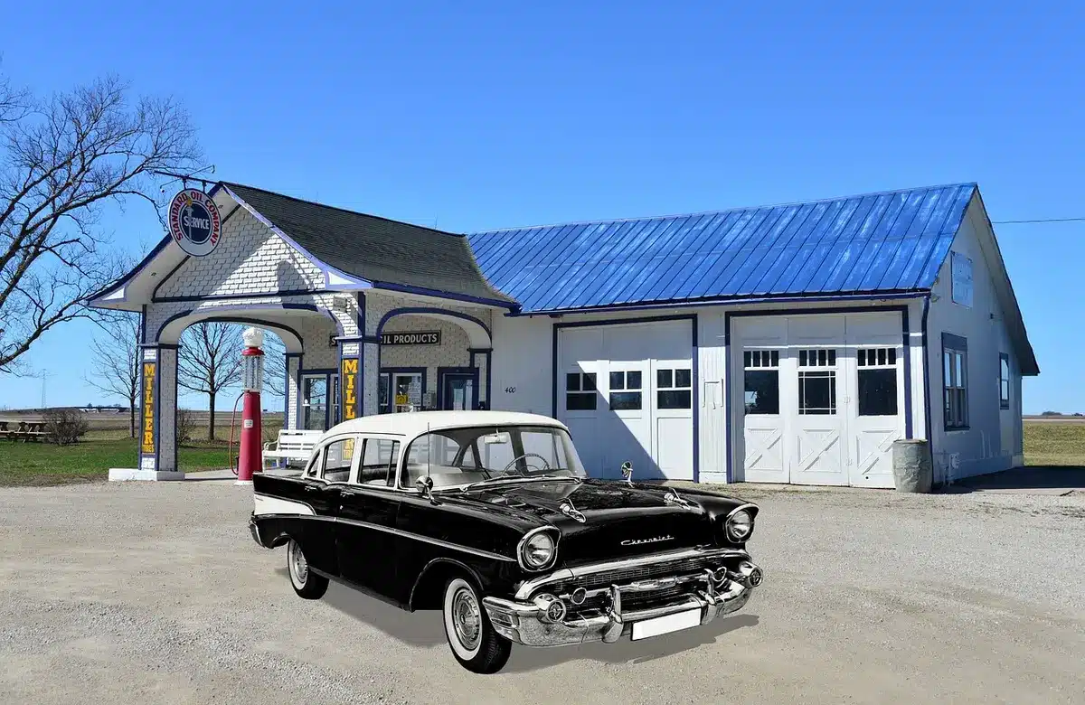 anonymous fuel station forecourt with a car queue and one closed pump, overcast sky